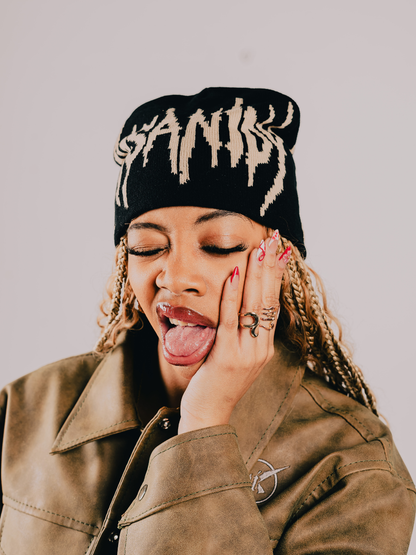 Insanidy knitwear black beanie at unseen grail. local brands south africa. streetwear. men and women. studio image female model front close up