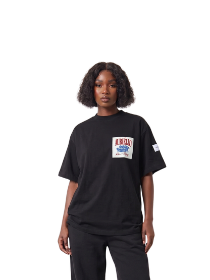 Auriello black oversized graphic vest at unseen grail. local brands south africa. streetwear. men and women. studio image female standing up