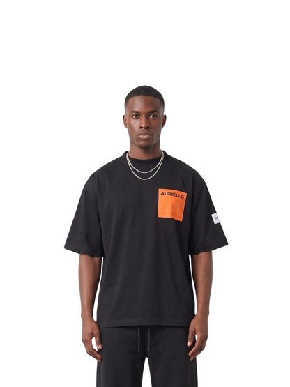 Auriello black oversized graphic vest at unseen grail. local brands south africa. streetwear. men and women. studio image male model orange pocket