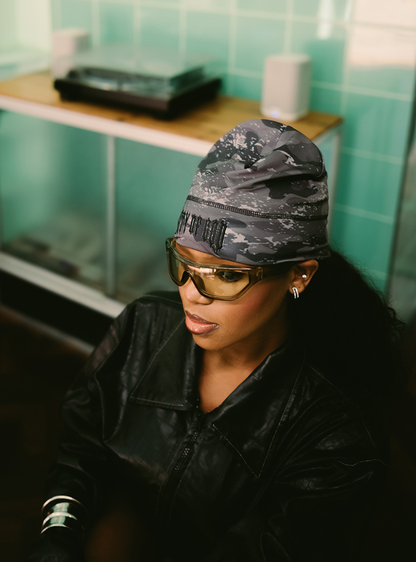 City of Gods black skull caps. local brands from south africa found at Unseen Grail. men and women. close up front female model in shop