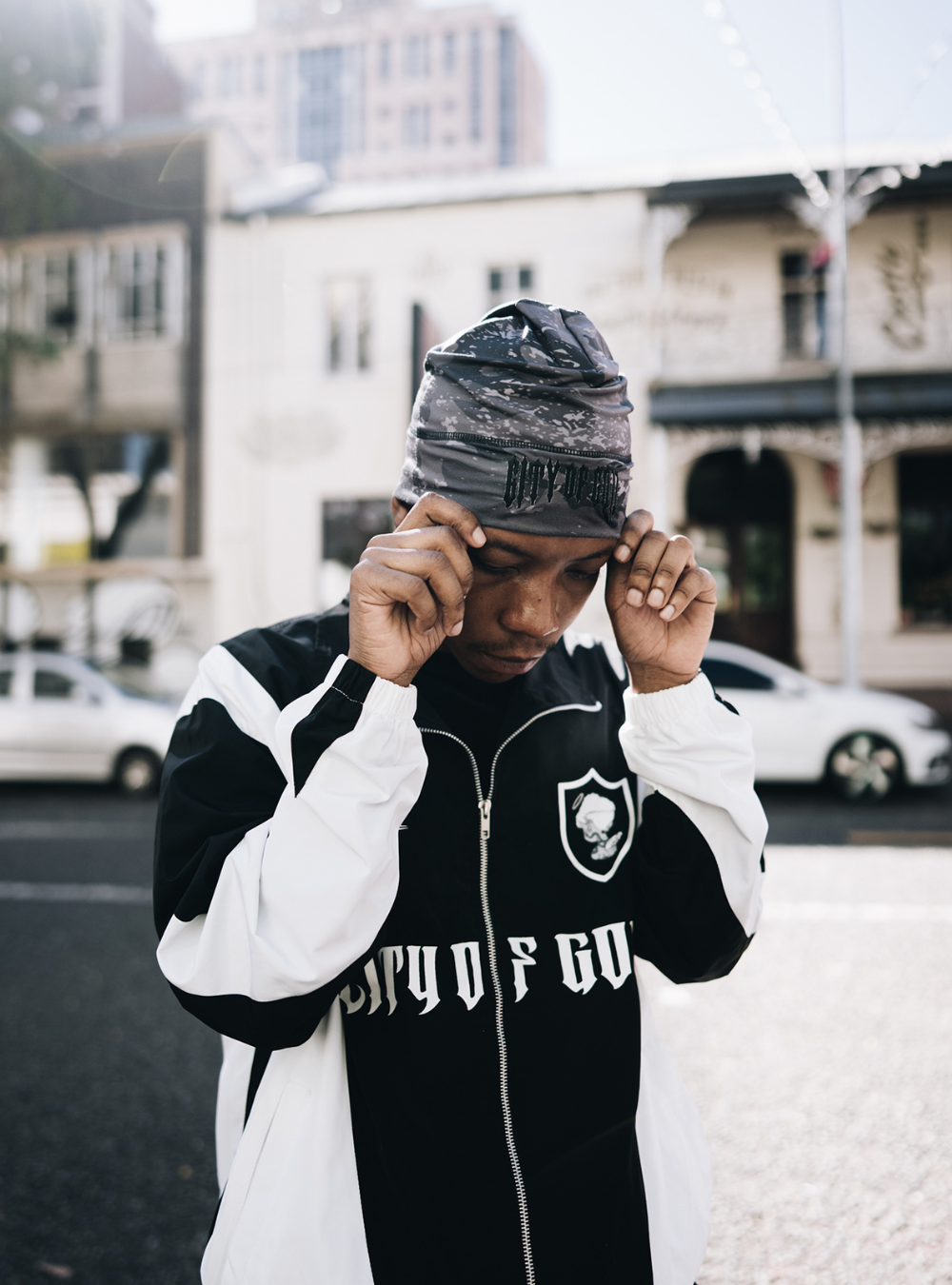 City of Gods black skull caps. local brands from south africa found at Unseen Grail. men and women. close up front male model holding beanie