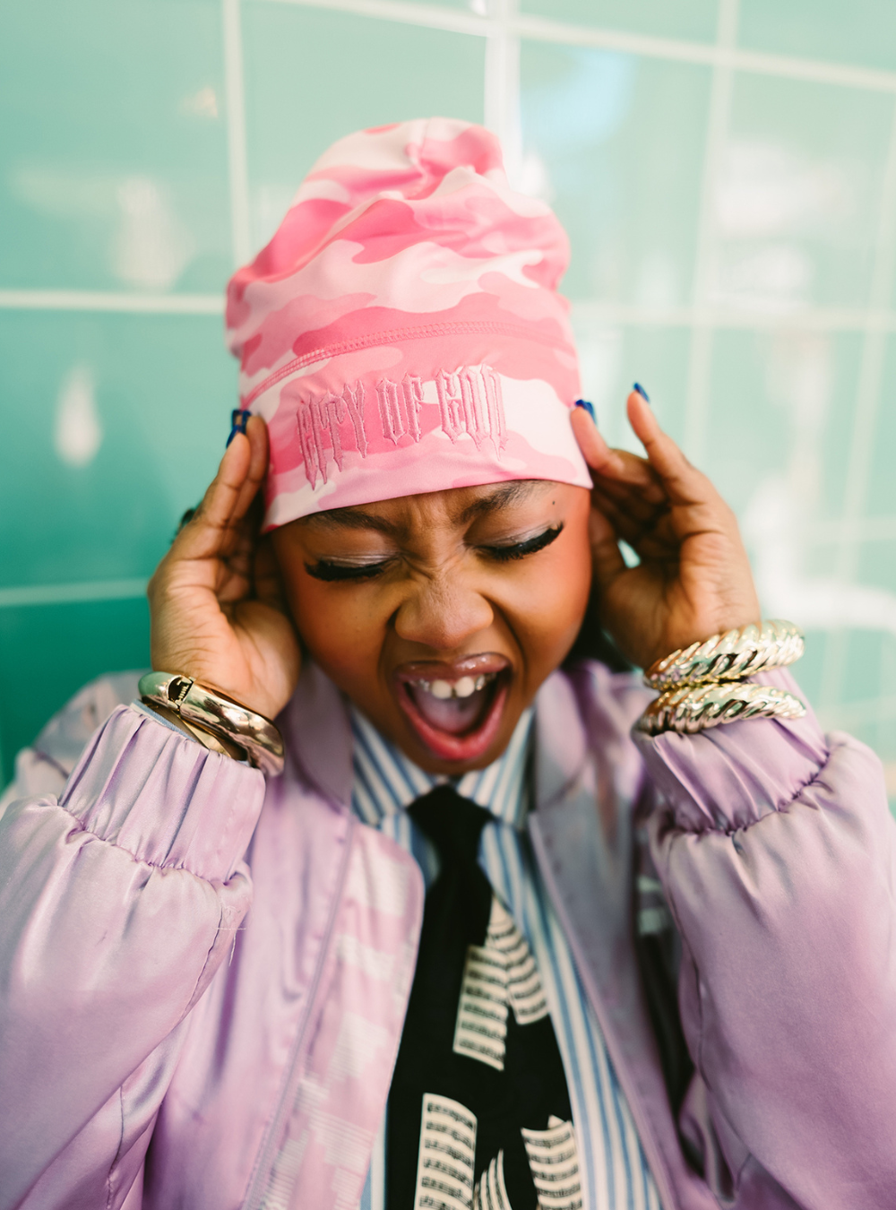 City of Gods pink camo skull caps. local brands from south africa found at Unseen Grail. men and women. female model holding head