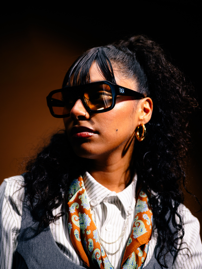 Dimas black frame orange lenses Eyewear unisex sunglasses collection modern fashion frames South African eyewear brand. studio image 1 female model
