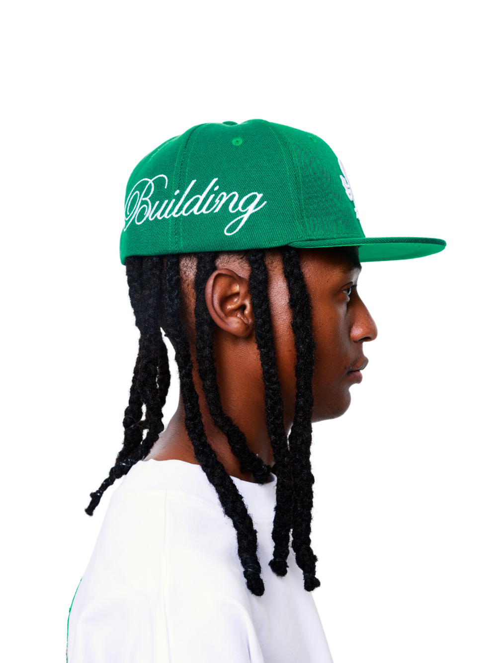Empire green fitted cap at unseen grail. local brands south africa. streetwear. men and women. studio image male model side
