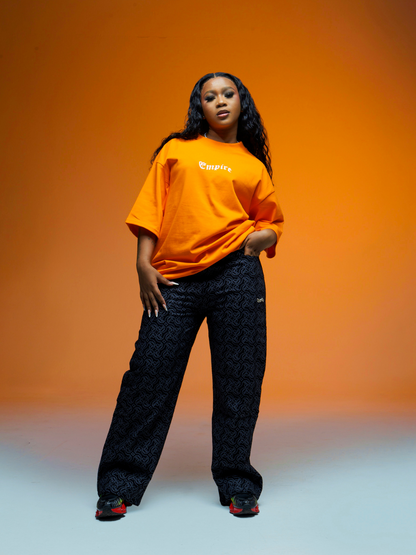 Empire orange oversized graphic t shirt at unseen grail. local brands south africa. streetwear. men and women. studio image female model full outfit
