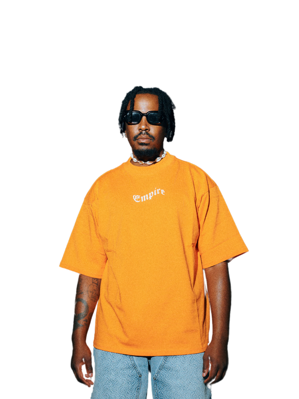 Empire orange oversized graphic t shirt at unseen grail. local brands south africa. streetwear. men and women. studio image male model close up