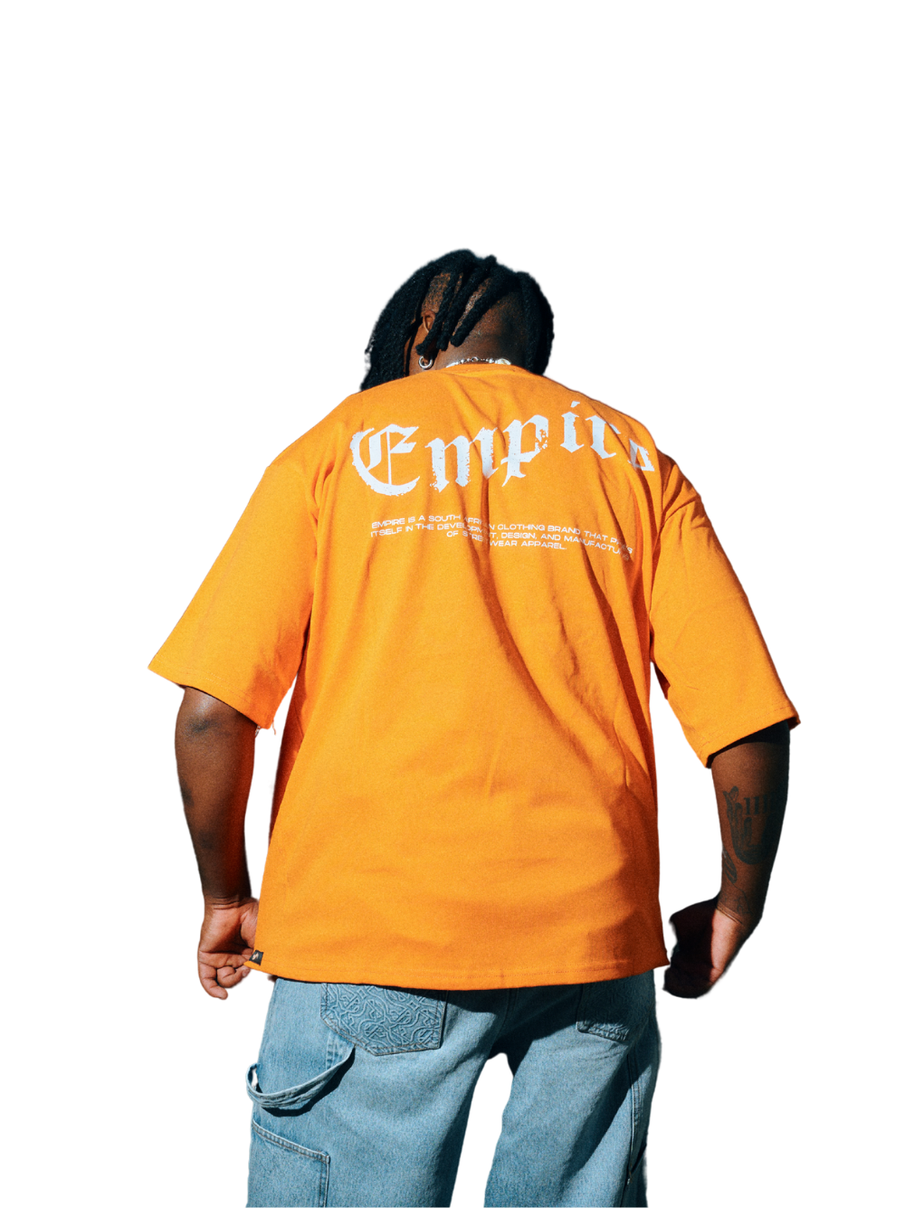 Empire orange oversized graphic t shirt at unseen grail. local brands south africa. streetwear. men and women. studio image male model close up back view