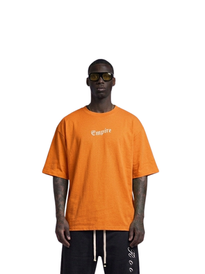 Empire orange oversized graphic t shirt at unseen grail. local brands south africa. streetwear. men and women. studio image male model front view