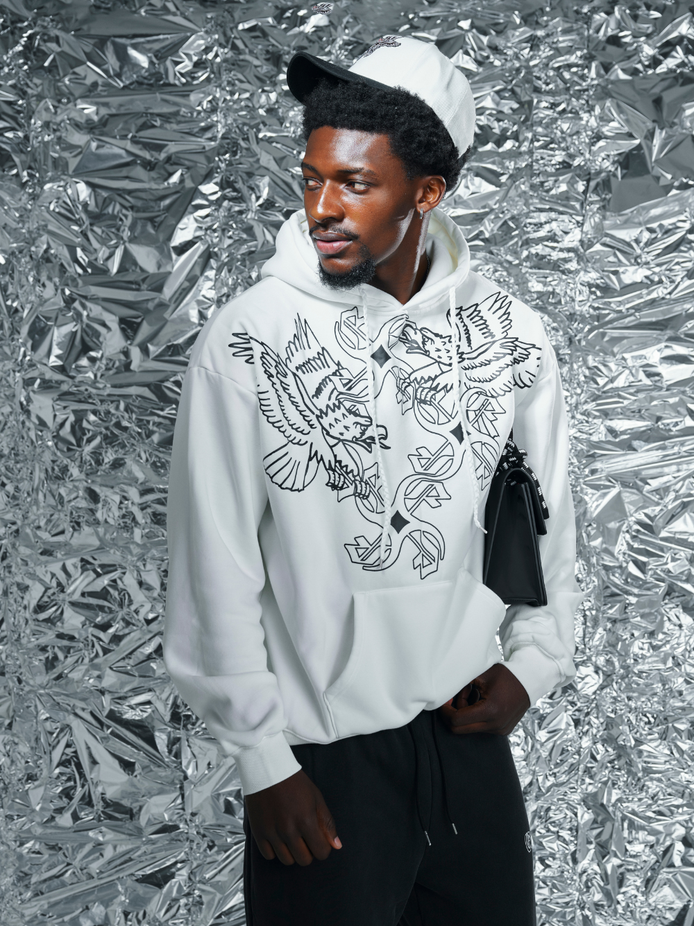 Empire white oversized graphic hoodie at unseen grail. local brands south africa. streetwear. men and women. studio image close up front male model