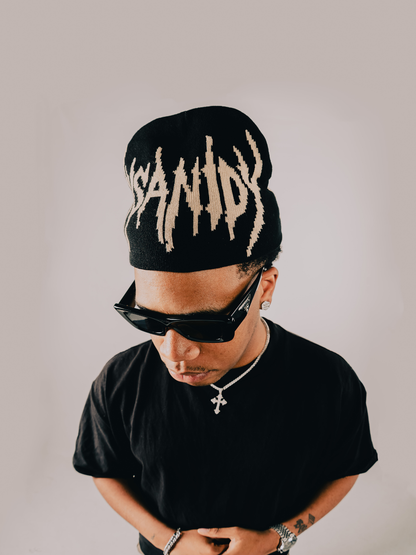 Insanidy knitwear black beanie at unseen grail. local brands south africa. streetwear. men and women. studio image male model front close up