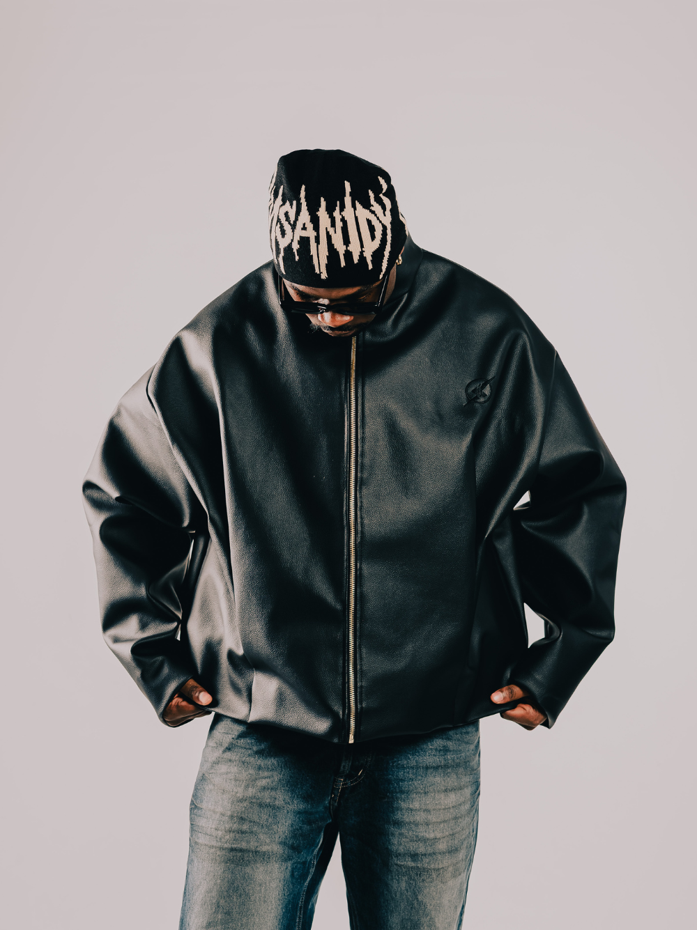 Insanidy knitwear black beanie at unseen grail. local brands south africa. streetwear. men and women. studio image male model front facing