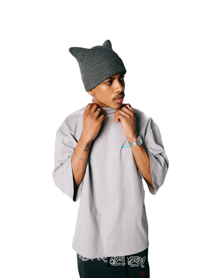Kai Eleven grey oversized graphic t shirt at unseen grail. local brands south africa. streetwear. men and women. male model front side view