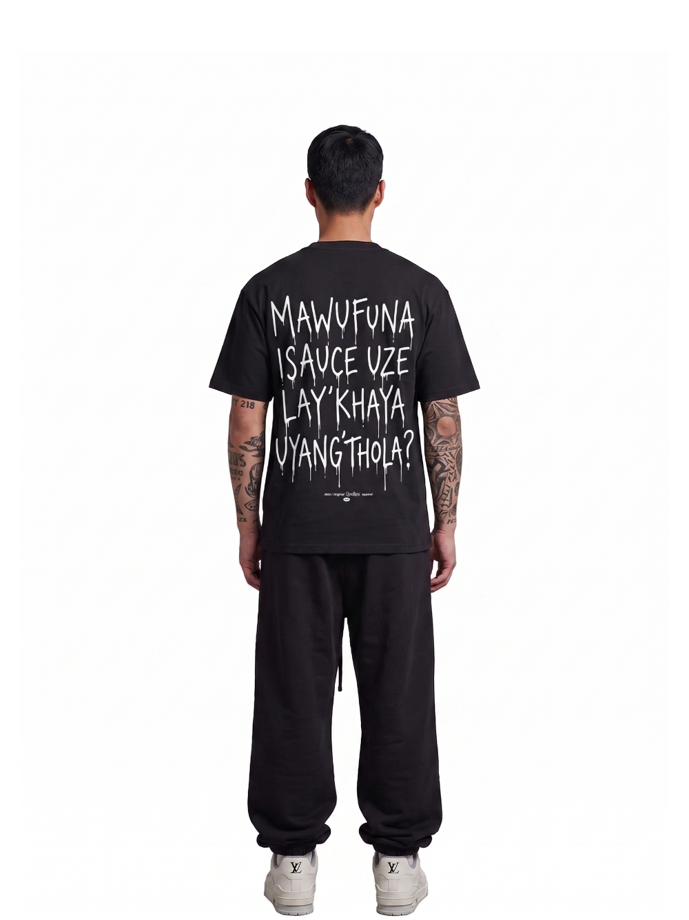 Mercha black oversized graphic t shirt at unseen grail. local brands south africa. streetwear. men and women. studio image behind male model full outift