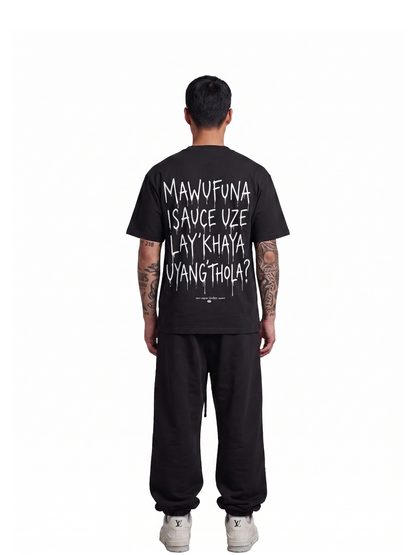 Mercha black oversized graphic t shirt at unseen grail. local brands south africa. streetwear. men and women. studio image behind male model full outift