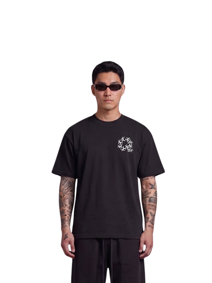 Mercha black oversized graphic t shirt at unseen grail. local brands south africa. streetwear. men and women. studio image male model front