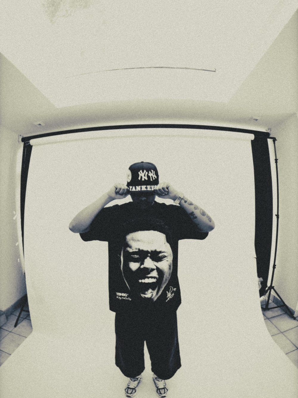 Mercha black oversized graphic vest at unseen grail. local brands south africa. streetwear. men and women. studio image a reece nasty c male model full outfit male