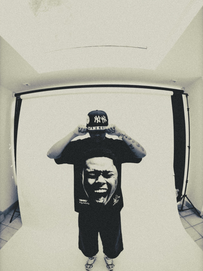 Mercha black oversized graphic vest at unseen grail. local brands south africa. streetwear. men and women. studio image a reece nasty c male model full outfit male
