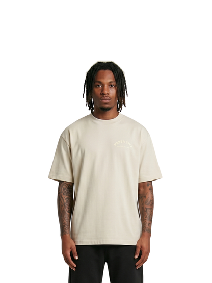 Paper city cream oversized graphic tshirt at unseen grail. local brands south africa. streetwear. men and women. male model front image