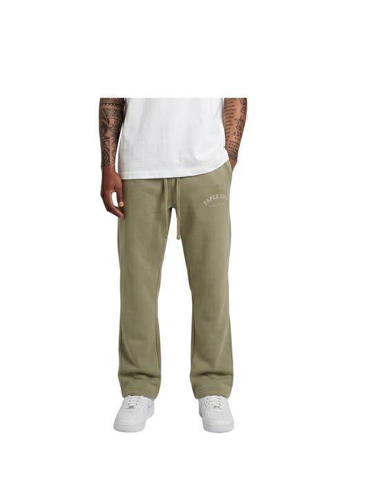 Paper city green oversized sweatpants  at unseen grail. local brands south africa. streetwear. men and women. male model front