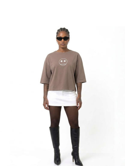Rare Blaq brown oversized graphic t shirt at unseen grail. local brands south africa. streetwear. men and women. studio image female model full front image