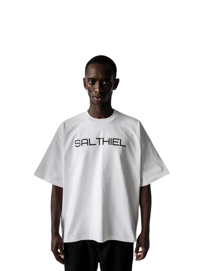 Salthiel white toversized graphic t shirt at unseen grail. local brands south africa. streetwear. men and women. male model front view