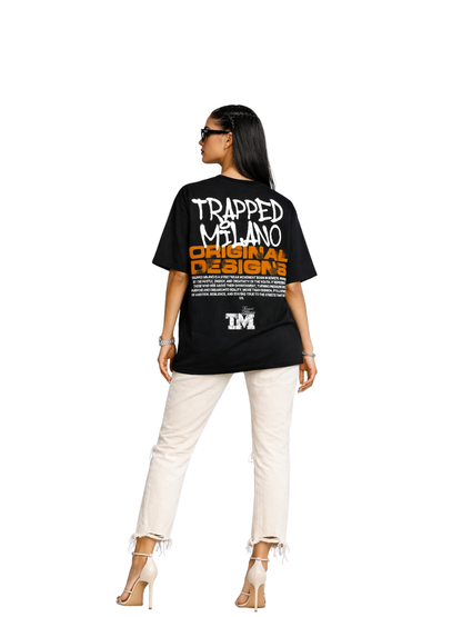 Trapped Milano black oversized graphic t shirt at unseen grail. local brands south africa. streetwear. men and women. studio image female model full outfit behind