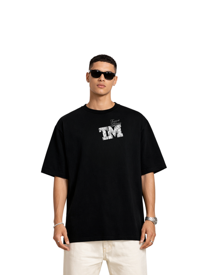 Trapped Milano black oversized graphic t shirt at unseen grail. local brands south africa. streetwear. men and women. studio image male model front