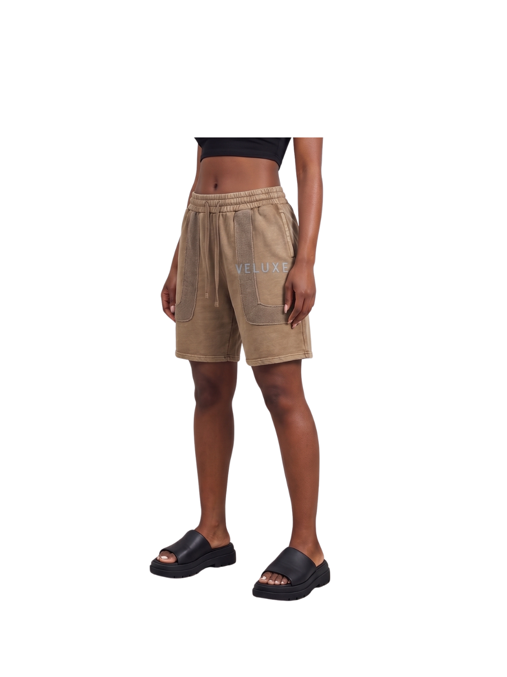 Veluxe brown oversized graphic shorts at unseen grail. local brands south africa. streetwear. men and women. studio image female model front