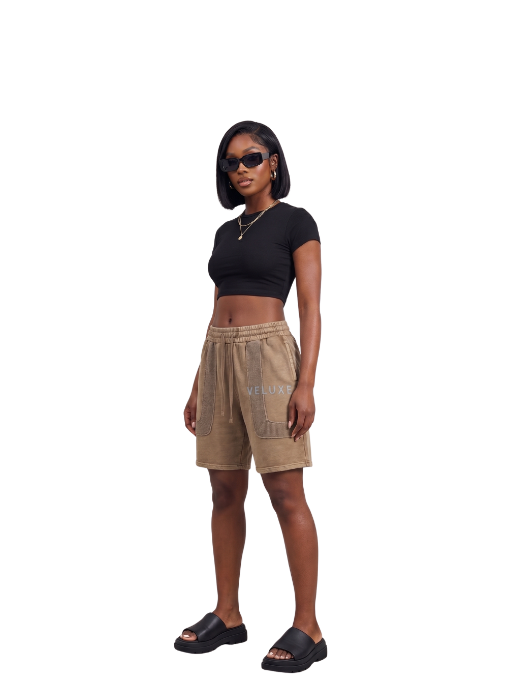 Veluxe brown oversized graphic shorts at unseen grail. local brands south africa. streetwear. men and women. studio image full outfit female