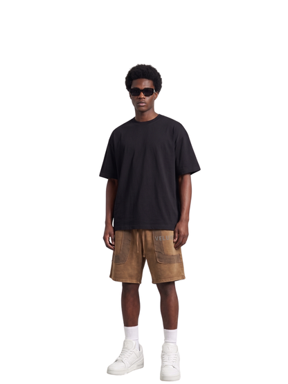 Veluxe brown oversized graphic shorts at unseen grail. local brands south africa. streetwear. men and women. studio image full outfit male
