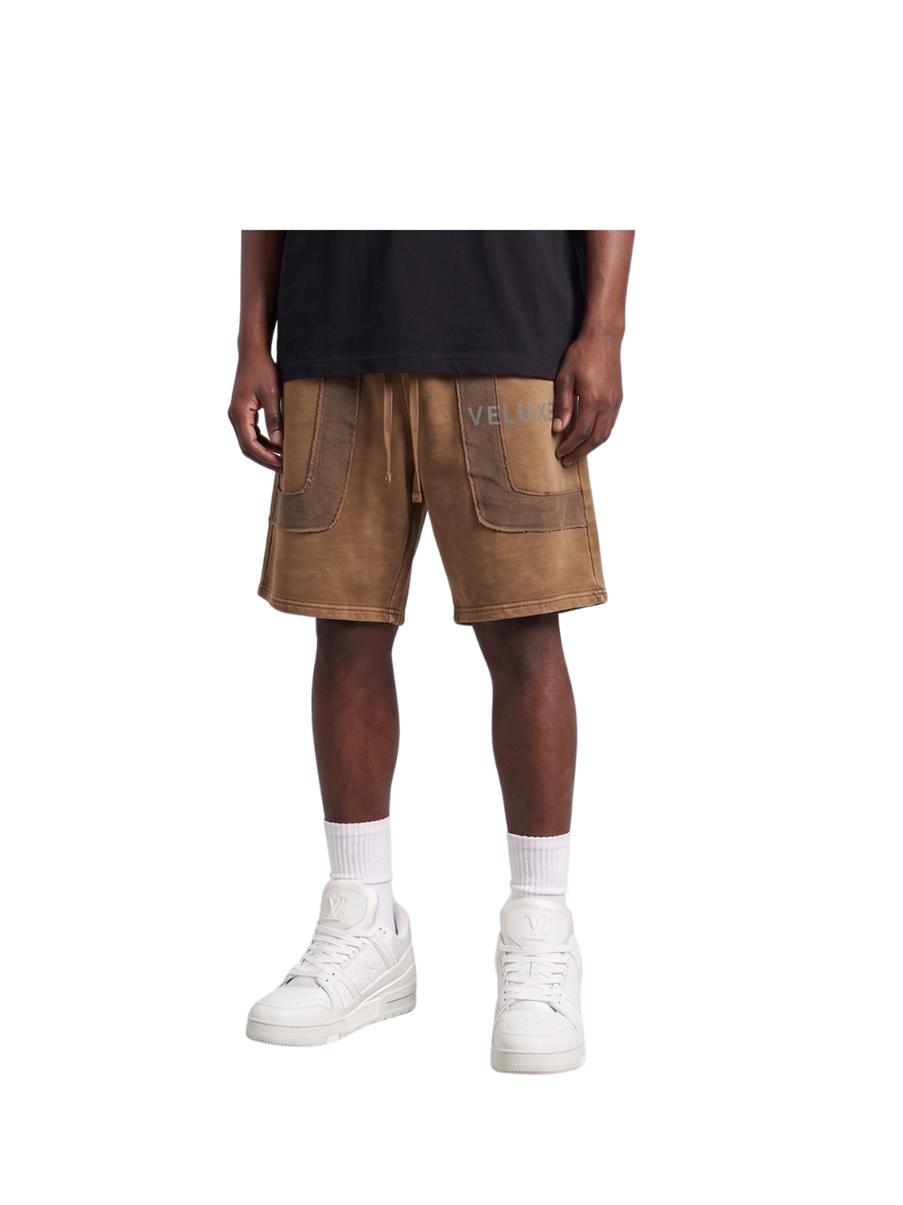 Veluxe brown oversized graphic shorts at unseen grail. local brands south africa. streetwear. men and women. studio image male model front