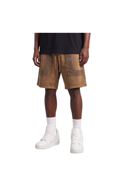 Veluxe brown oversized graphic shorts at unseen grail. local brands south africa. streetwear. men and women. studio image male model front