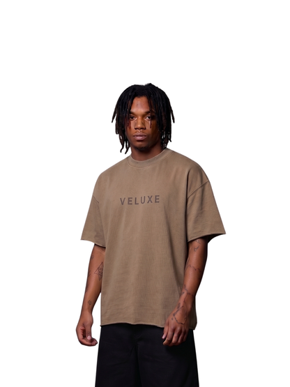Veluxe brown oversized graphic t shirt at unseen grail. local brands south africa. streetwear. men and women. studio image male model front