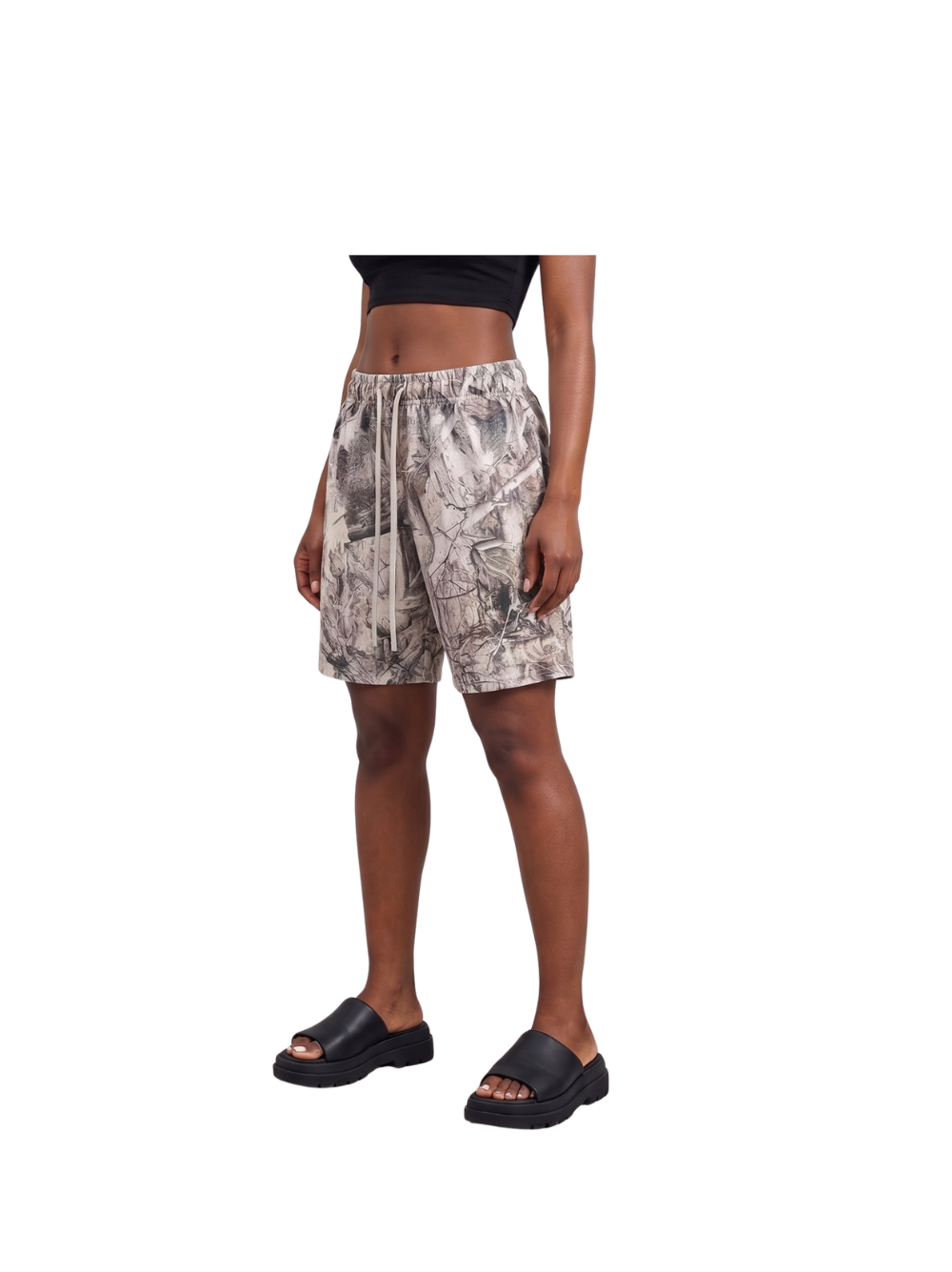Veluxe camo oversized graphic shorts at unseen grail. local brands south africa. streetwear. men and women. studio image female model full outfit