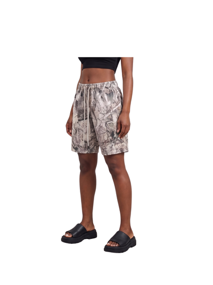 Veluxe camo oversized graphic shorts at unseen grail. local brands south africa. streetwear. men and women. studio image female model full outfit