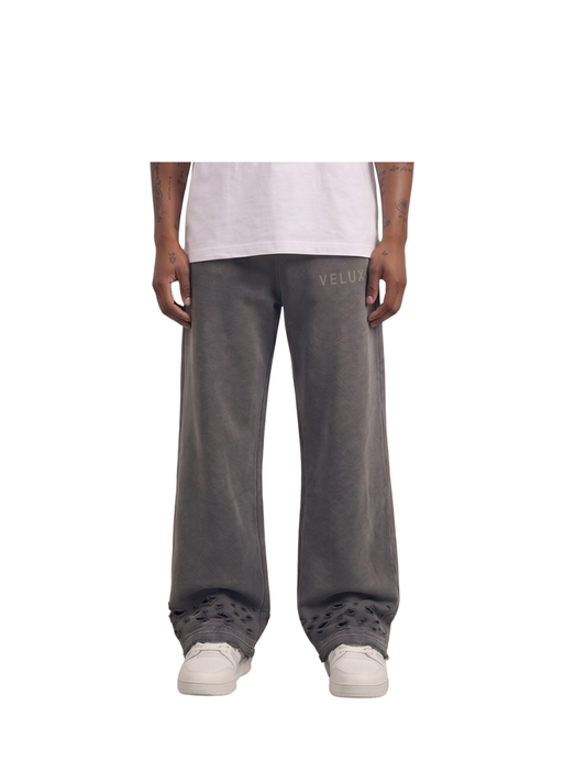 Veluxe grey oversized graphic sweatpants at unseen grail. local brands south africa. streetwear. men and women. studio image male model