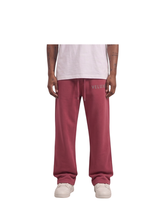 Veluxe red oversized graphic sweatpants at unseen grail. local brands south africa. streetwear. men and women. studio image male model