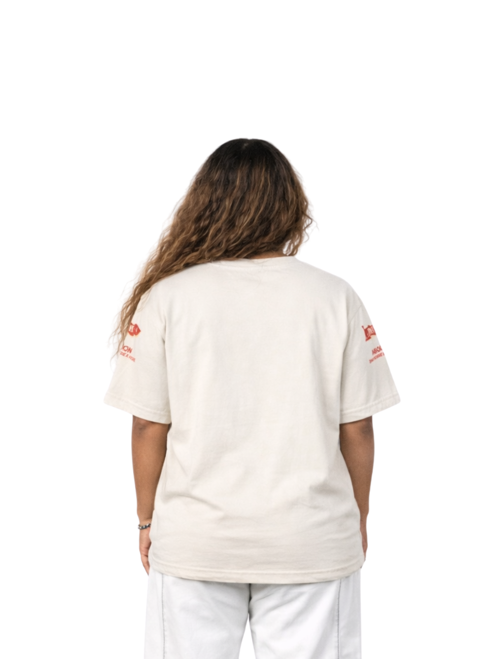 aimon beige oversized graphic tshirt at unseen grail. local brands south africa. streetwear. men and women. studio image female model behind