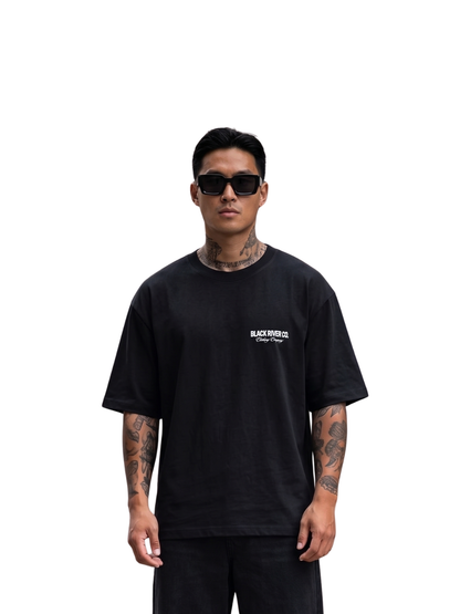 black river black oversized graphic t-shirt at unseen grail. local brands south africa. streetwear. men and women. studio image front male model. galxboy, bantu