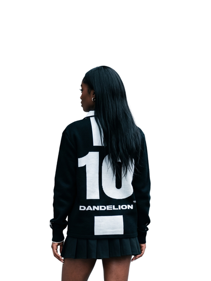 dandelion black and white knitwear sweater at unseen grail. local brands south africa. streetwear. men and women. studio image female model behind view