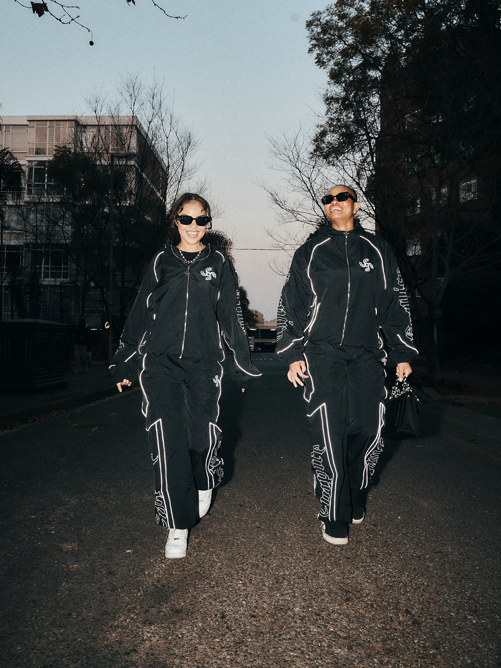 empire black oversized graphic tracksuit at unseen grail. local brands south africa. streetwear. men and women. group image galxboy, bantu full set women walking together