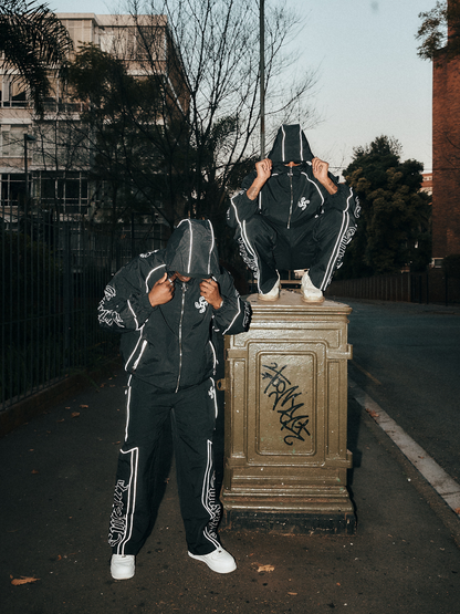 empire black oversized graphic tracksuit at unseen grail. local brands south africa. streetwear. men and women. group image galxboy, bantu men talking. streetwear