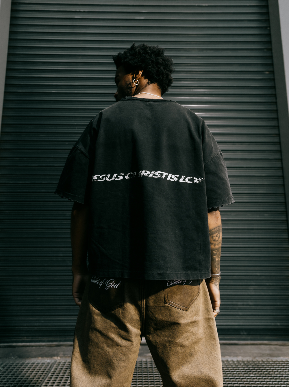 seventwelve studios black oversized tshirt at unseen grail. local brands south africa. streetwear. men and women. male model back full outfit