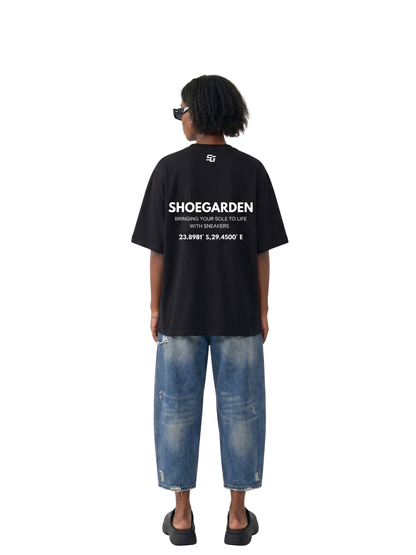 shoe garden black and white oversized tshirt at unseen grail. men and women. south africa top local brands all at unseen grail. studio image female model behind full outfit