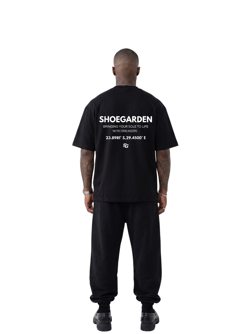 shoe garden black and white oversized tshirt at unseen grail. men and women. south africa top local brands all at unseen grail. studio image male model behind full outfit