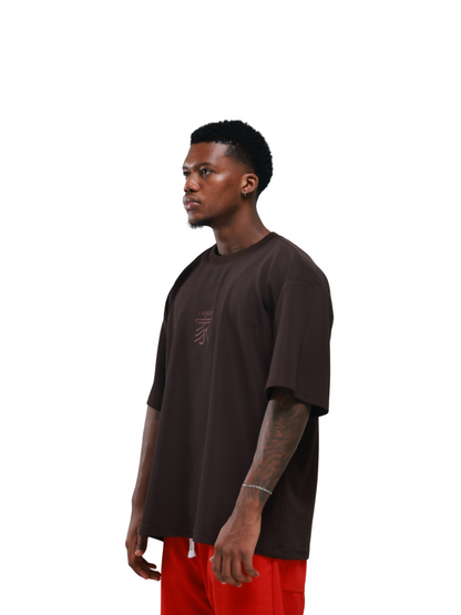 yhooa brown oversized graphic t shirt at unseen grail. local brands south africa. streetwear. men and women. studio image female model side