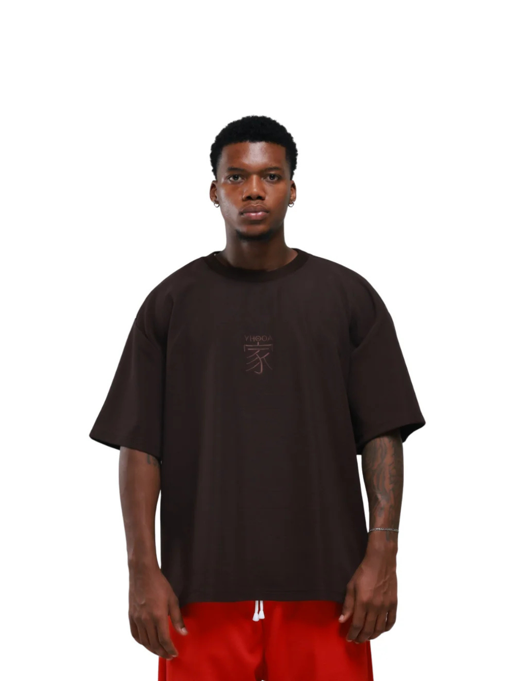 yhooa brown oversized graphic t shirt at unseen grail. local brands south africa. streetwear. men and women. studio image male model front